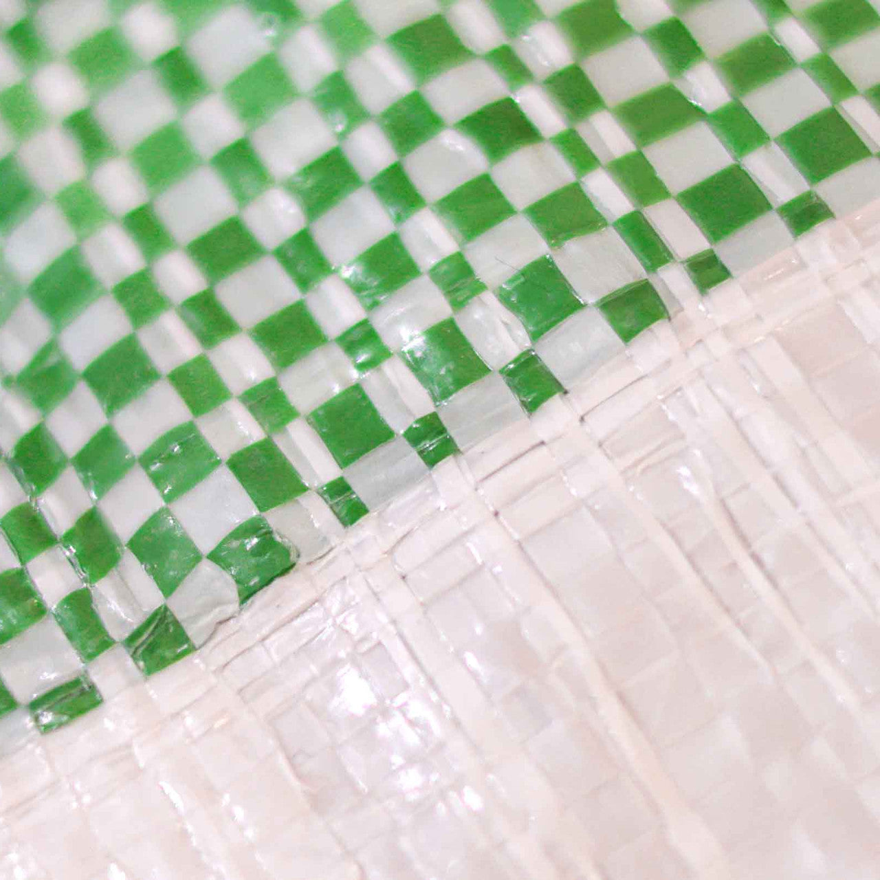 Close-up of 170gsm striped tarpaulin for sheltering goods and surfaces.