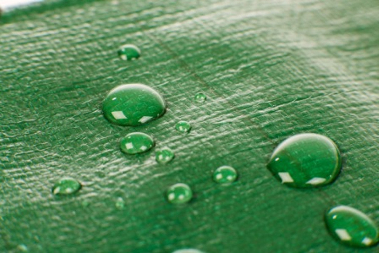 250gsm heavy-duty tarpaulin in green and brown shielding surfaces from rain and dust.