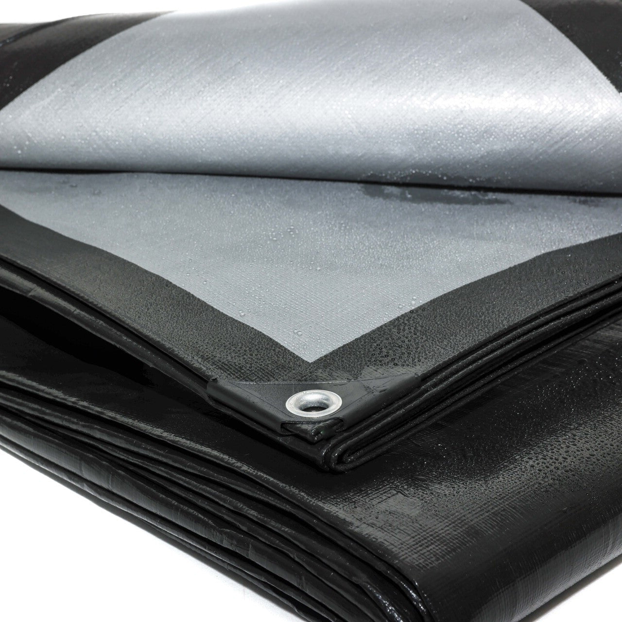 Durable 270gsm black/silver tarpaulin protecting equipment, vehicles, and cargo.