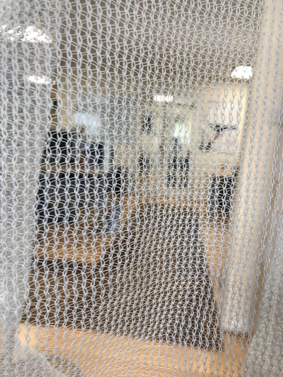 Close-up of heavy-duty debris netting for safety and material containment.