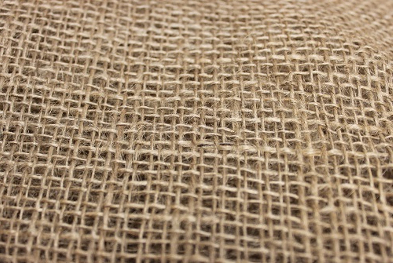 Natural jute hessian rolls neatly arranged for storage or commercial use
