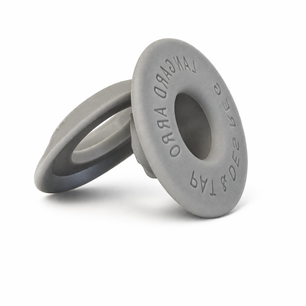 Round grey plastic eyelets neatly arranged on a flat surface for DIY projects.